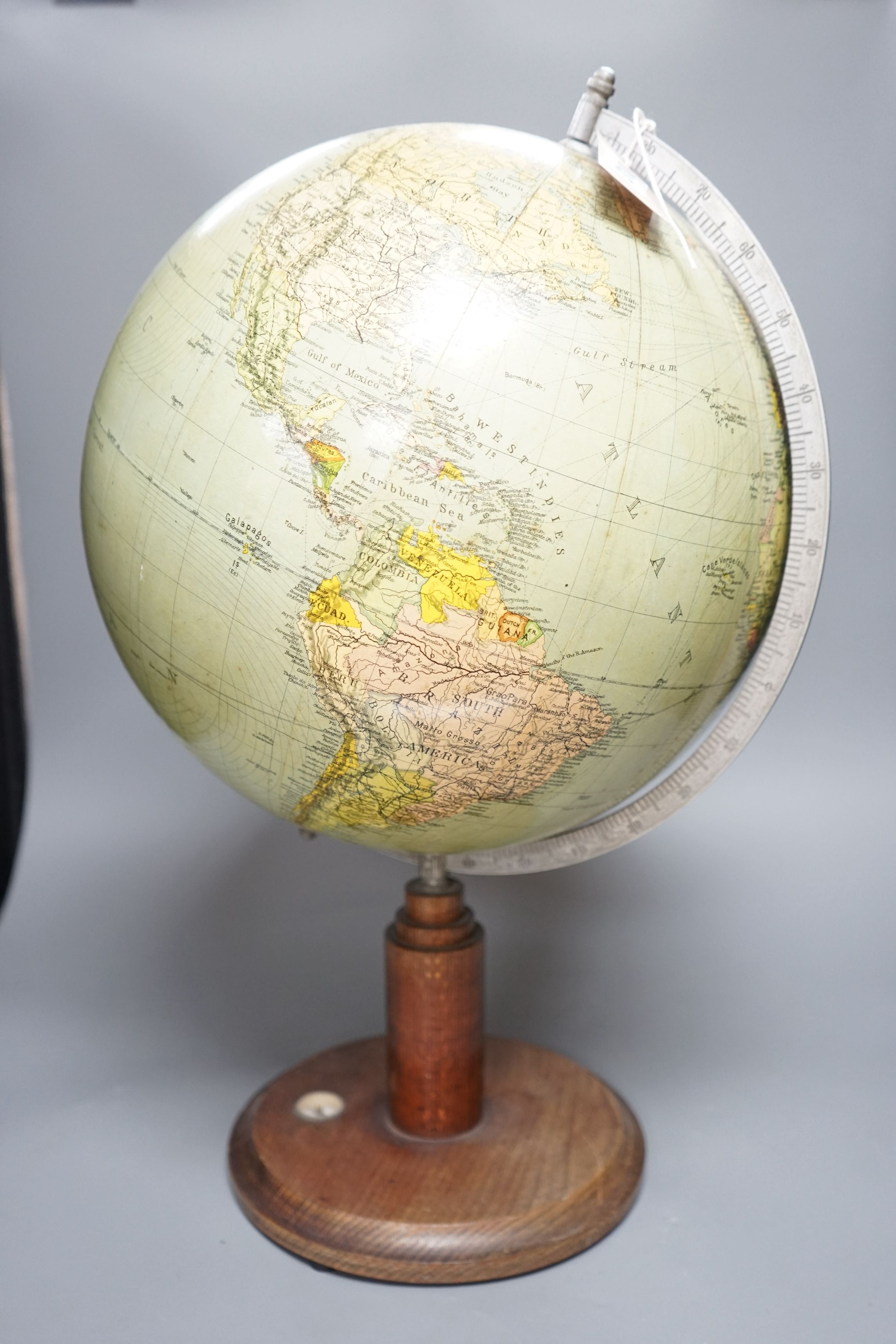 A mid 20th century globe on a revolving stand with an inset compass, 54cms high including stand